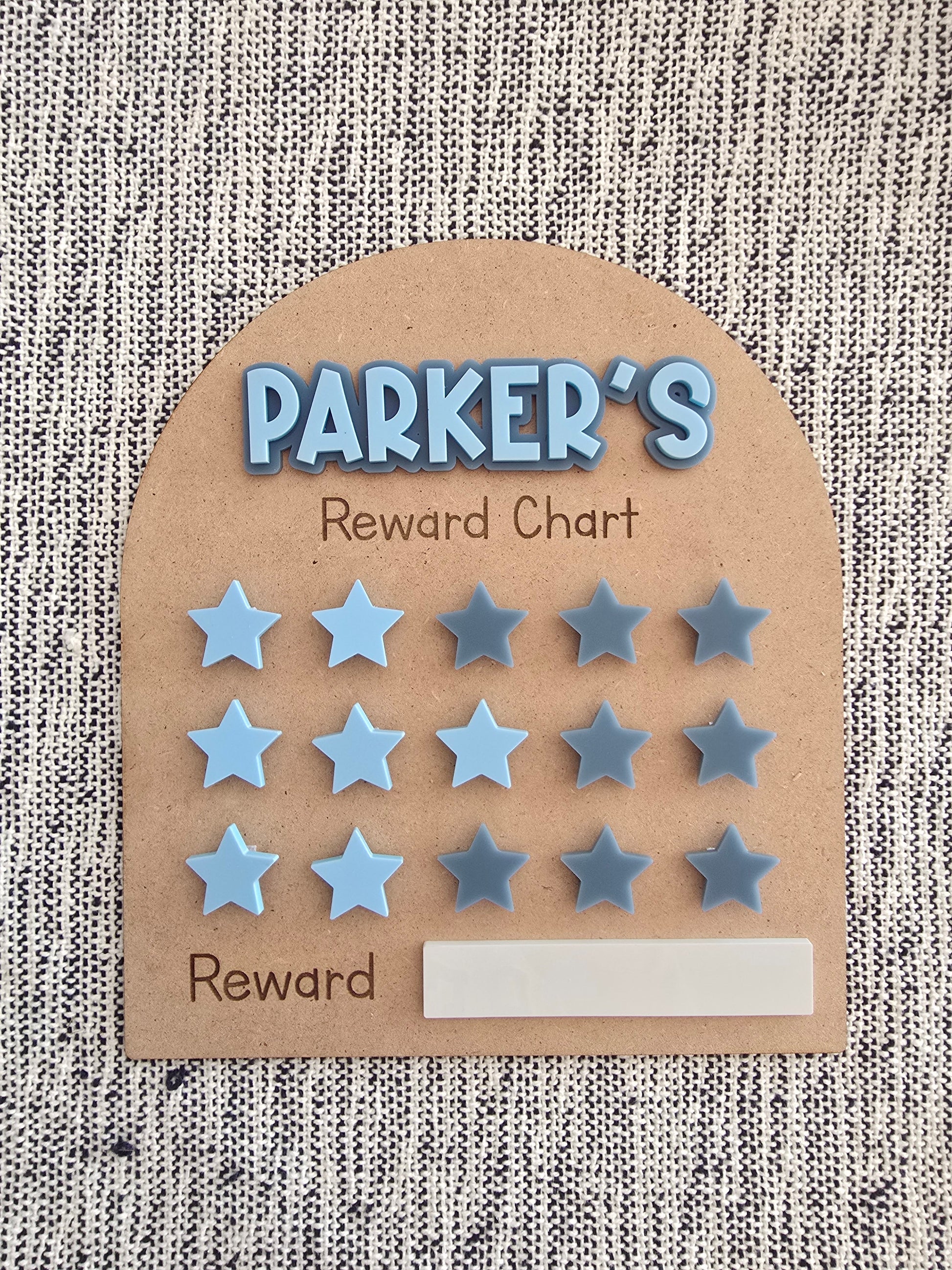 Children's reward chart with stars for 'Parker' on a textured background